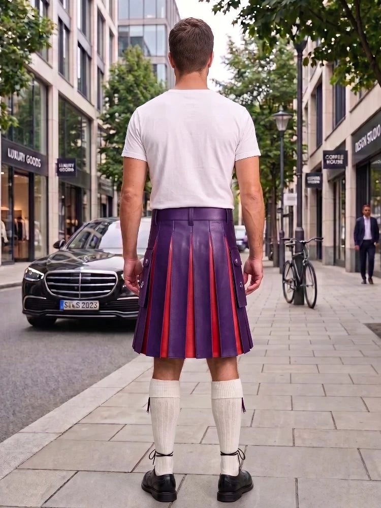 A man standing on a city sidewalk, viewed from behind, wearing a white t-shirt, a purple pleated leather kilt with red stripes, white knee-high socks, and black shoes. Buildings, trees, a parked black Mercedes, and a bicycle are visible in the background.