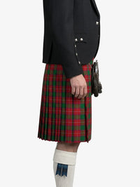 Person wearing a black jacket and red plaid kilt on a white background