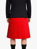 Person wearing a black jacket and red pleated kilt on a white background