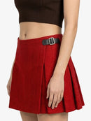 Red pleated skirt with a black belt on a white background