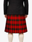 Person wearing a black jacket and red plaid kilt on a white background