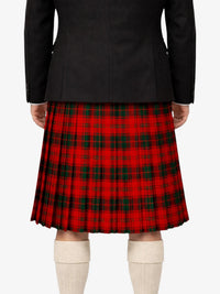 Person wearing a black jacket and red plaid kilt on a white background