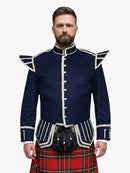 Man wearing a navy doublet jacket with white accents and a red plaid kilt on a white background