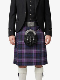 Person wearing a black jacket, purple plaid kilt, and white knee-high socks on a white background