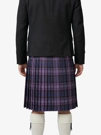 Person wearing a black jacket and purple plaid kilt on a white background