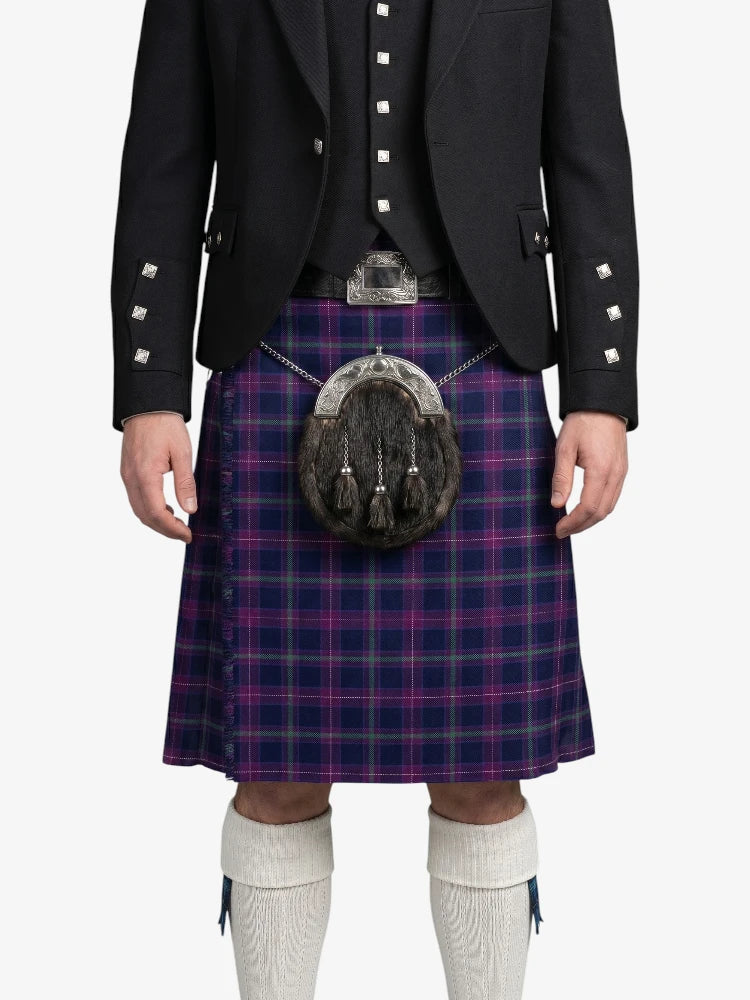 Person wearing a traditional Scottish kilt with a sporran on a white background