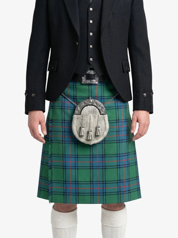 Person wearing a green plaid kilt with a black jacket on a white background