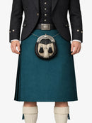 Person wearing a dark jacket, teal kilt, and white socks on a white background