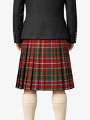 Person wearing a black coat and red plaid kilt on a white background