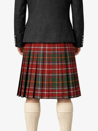 Person wearing a black coat and red plaid kilt on a white background
