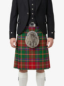 Person wearing a traditional Scottish kilt with a tartan pattern on a white background