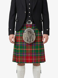 Person wearing a traditional Scottish kilt with a tartan pattern on a white background