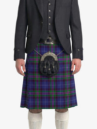 Person wearing a dark gray suit with a blue plaid kilt on a white background