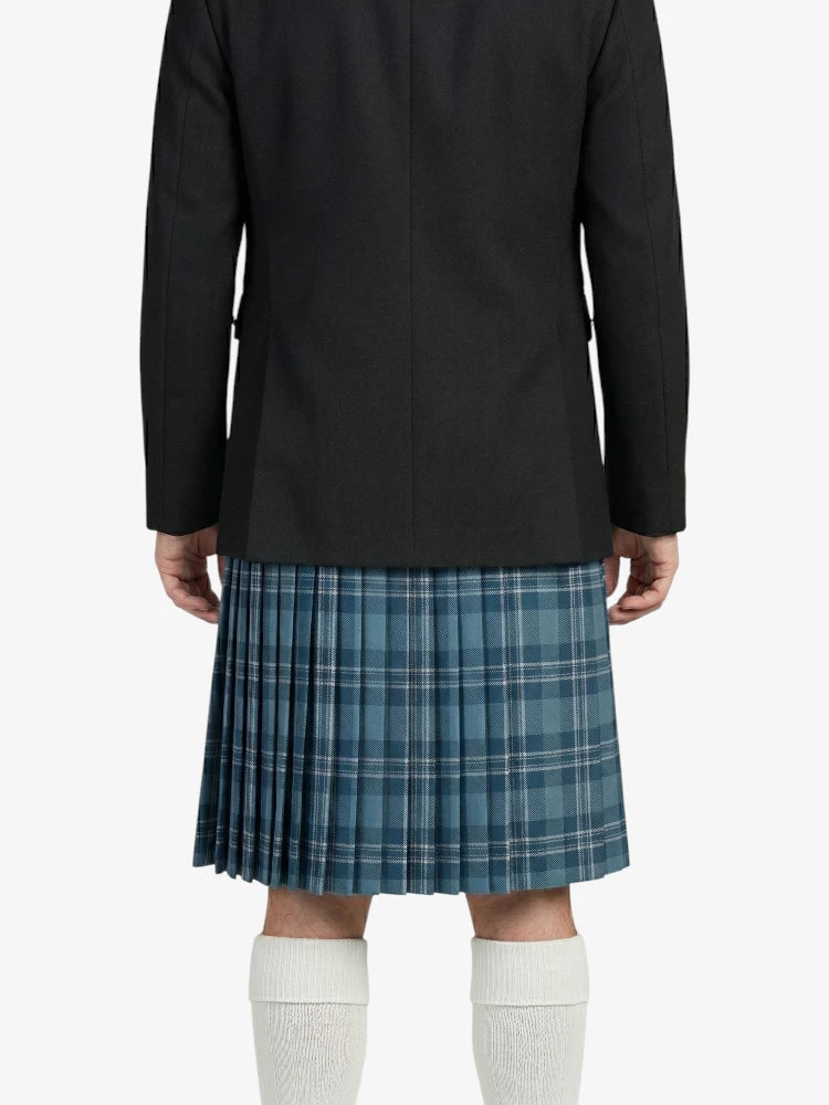 Person wearing a black coat, blue plaid kilt, and white knee-high socks on a light purple background