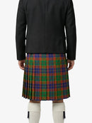 Person wearing a black jacket and a colorful plaid kilt on a white background