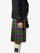 Person wearing a black jacket and a plaid kilt on a white background