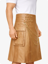 Tan leather skirt with gold chain detail worn by a person on a white background