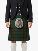 Person wearing a traditional Scottish kilt with a tartan pattern on a white background