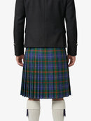 Person wearing a black jacket and blue plaid kilt on a white background