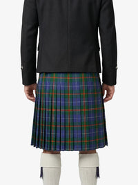 Person wearing a black jacket and blue plaid kilt on a white background