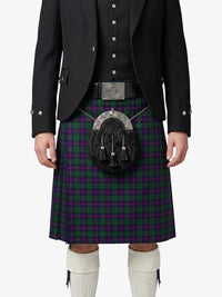 Person wearing a traditional Scottish kilt with a sporran on a white background