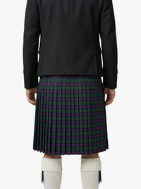 Person wearing a black jacket and a plaid kilt on a white background