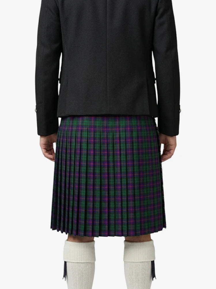 Person wearing a black jacket and a plaid kilt on a white background