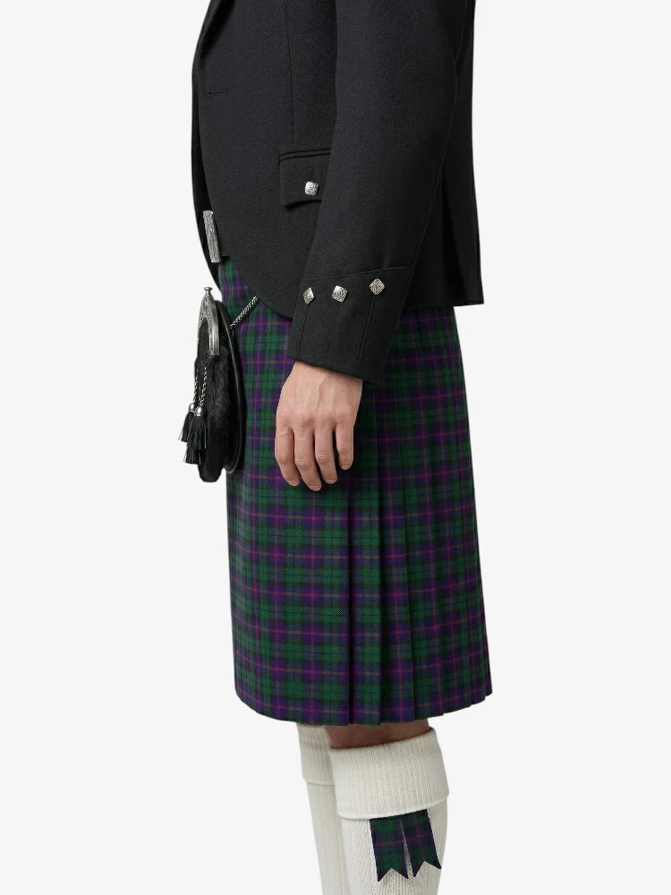 Person wearing a black jacket and plaid kilt on a white background