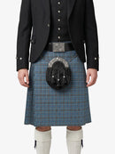 Person wearing a traditional Scottish kilt with a jacket on a white background