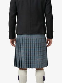 Person wearing a black jacket and blue plaid kilt on a white background