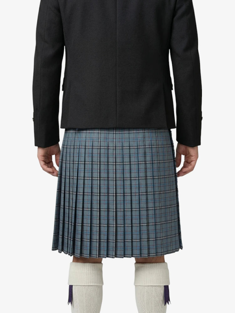 Person wearing a black jacket and blue plaid kilt on a white background