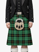 Person wearing a green plaid kilt with a black jacket on a white background