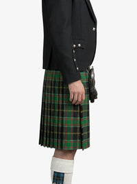 Person wearing a black jacket and green plaid kilt on a white background