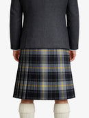 Person wearing a dark gray jacket and plaid kilt on a white background