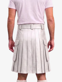 A person shown from the back wearing a light beige pleated kilt-style skirt with a matching belt and side flap pockets, paired with a pale pink T-shirt and light socks, against a plain light background.