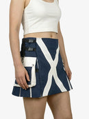 Person wearing a navy blue skirt with white stripes and black accents on a white background