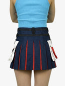 Person wearing a blue pleated skirt with red stripes on a white background
