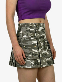 Person wearing a camouflage skirt and purple top on a white background