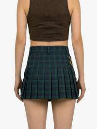 Person wearing a brown crop top and green plaid skirt on a white background