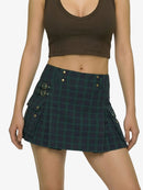 Person wearing a green plaid skirt and brown crop top on a white background