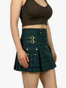 Green plaid skirt with gold buttons worn by a person on a white background